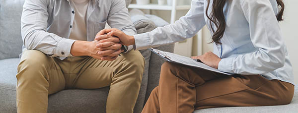 Counselor holding student's hand